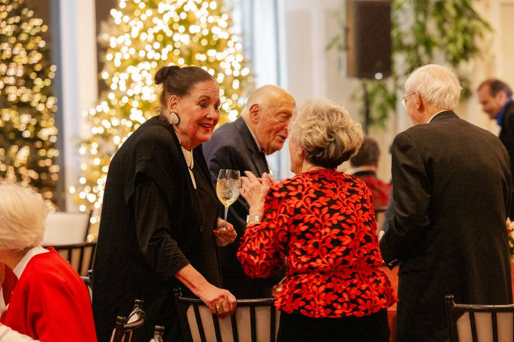 Dottie Johnson speaking with other guest at party